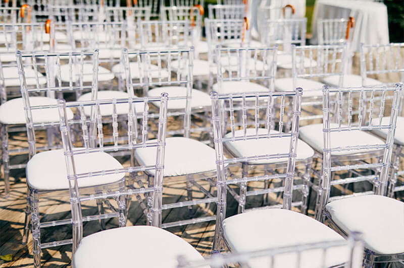 clear resin chiavari chairs with white cushions